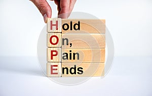 HOPE, hold on, pain ends symbol. Wooden cubes with words `HOPE, hold on, pain ends. Beautiful white background, copy space.