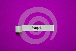 Hope, Inspiration, Motivation and business concept on purple torn paper photo