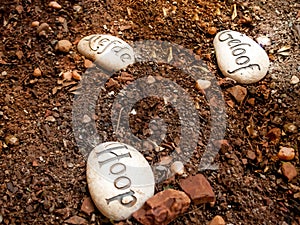 Hope Love and Faith message on stones placed on ground