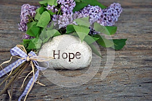 Hope on stone with lilacs