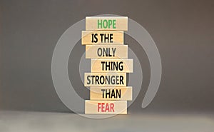 Hope stronger than fear symbol. Concept words Hope is the only thing stronger than fear on wooden blocks on a beautiful grey