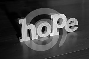 Hope, text words typography written with wooden letter on black background, life and business motivation inspirational