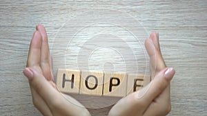 Hope word made by female hands, family creation, expectancy of baby, happiness