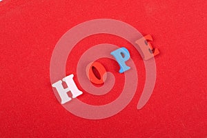 HOPE word on red background composed from colorful abc alphabet block wooden letters, copy space for ad text. Learning english