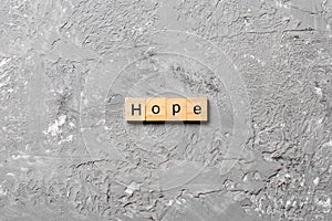 Hope word written on wood block. hope text on table, concept