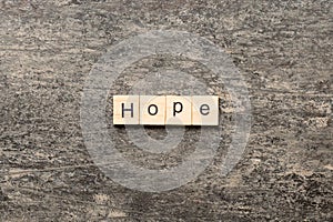 hope word written on wood block. hope text on table, concept