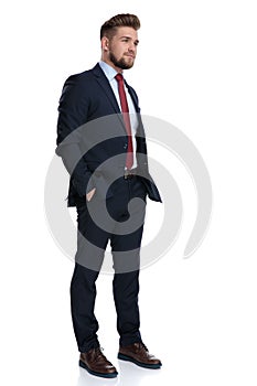 Hopeful businessman holding his hands in his pockets