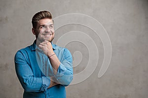 Hopeful casual man wondering and looking away