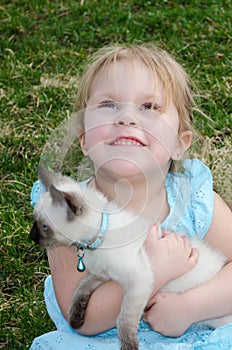 Hopeful child with kitten