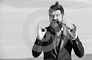 Hopeful and confident about future. Alright gesturing. Man bearded optimistic businessman wear formal suit sky