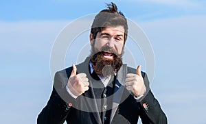 Hopeful and confident about future. Thumbs up gesture. Man bearded optimistic businessman wear formal suit sky