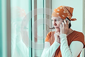 Hopeful female carpenter talking on mobile phone