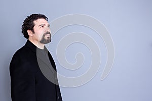 Hopeful man looking away over gray background