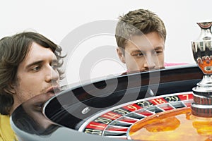 Hopeful Men Watching Roulette Wheel Spin