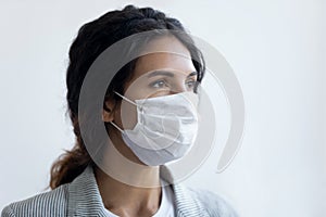 Hopeful woman in medical mask home for pandemic end