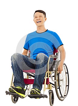 Hopeful young man sitting on a wheelchair
