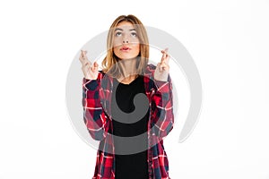 Hopeful young woman gesturing with fingers.