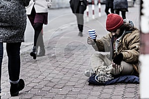 Hopeless beggar on the sidewalk