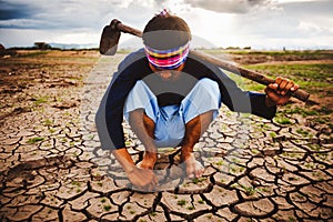 Hopeless and lonely Farmer sitiing on dry ground and finding Living plants. Global warming crisis