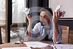 Hopeless miserable man holding crumpled paper