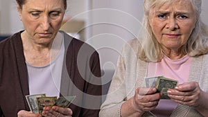 Hopeless old females counting small pension, pensioner poverty, social subsidy