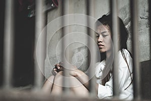 The hopeless slave girl is in a cell. Women violence and abused concept, Imprisonment, Female prisoner,  human trafficking Concept photo