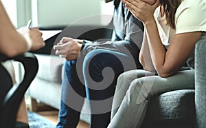 Hopeless and upset couple in therapy. Counseling or meeting with marriage counselor or adoption psychologist. Argument and dispute