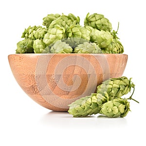 Hops in wooden bowl isolated on white background.