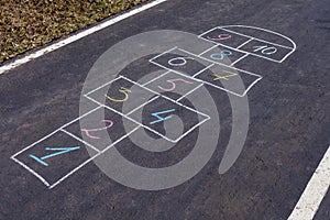 Hopscotch game drawn with chalk on the asphalt