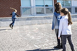 Hopscotch on the schoolyard with friends play together