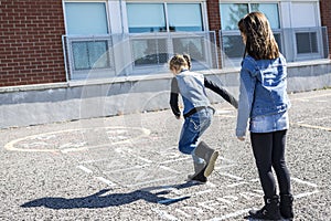 Hopscotch on the schoolyard with friends play together