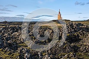 Hopsnes Lighthouse surrounded by lava field, Grindavik, Reykjanes Peninsula, Iceland