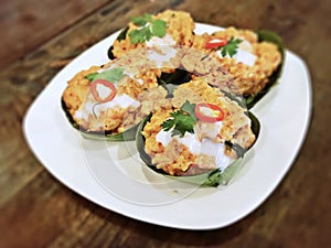 Hor Mok Pla - steamed fish in coconut milk and chili paste wrapped with banana leaves photo