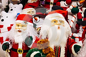 Horde of Santa Claus dolls and polar bears dolls on christmas background.