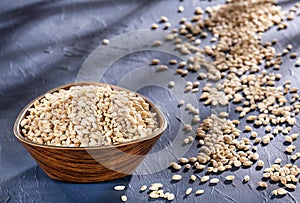 Hordeum vulgare - Dried pearl barley in a wooden bowl
