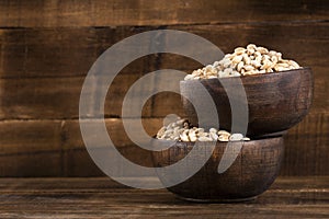 Hordeum vulgare - Pearl barley in two wooden bowls