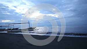 Horison view with cloudy sky on sunset and Bali sea side with boats.