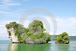 Horizon view of a big horizontal rock cliff with green vegetation, Krabi Thailand.