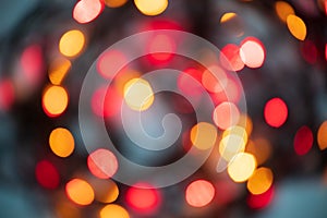 Horizontal abstract bokeh background of evening festive lights in red, yellow and orange round shape lights. Christmas, New Year