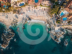 Horizontal aerial view of Conchas Chinas Beach in Mexico showing clear turquoise water in ocean photo