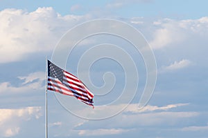 Horizontal American Flag Against a Cloudly Sky. Flag is unfurle
