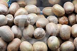 Horizontal background of fresh brown kiwis