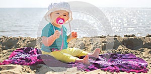 Horizontal background of newborn at beach with paciifier