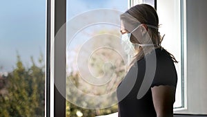 Horizontal background of woman in isolation opening window taking fresh air against virus outbreak hypochondria photo
