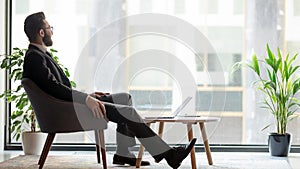 Horizontal banner middle eastern ethnicity businessman resting looking out window