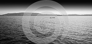 Horizontal black and white boat in ocean