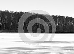 Horizontal black and white shadows on frozen river landscape background