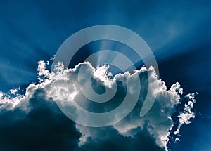 Horizontal blue dramatic cloudscape with rays of light