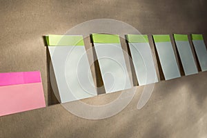 Horizontal board with many white sticky notes pinned