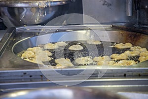 Horizontal bunuelos cooking in oil